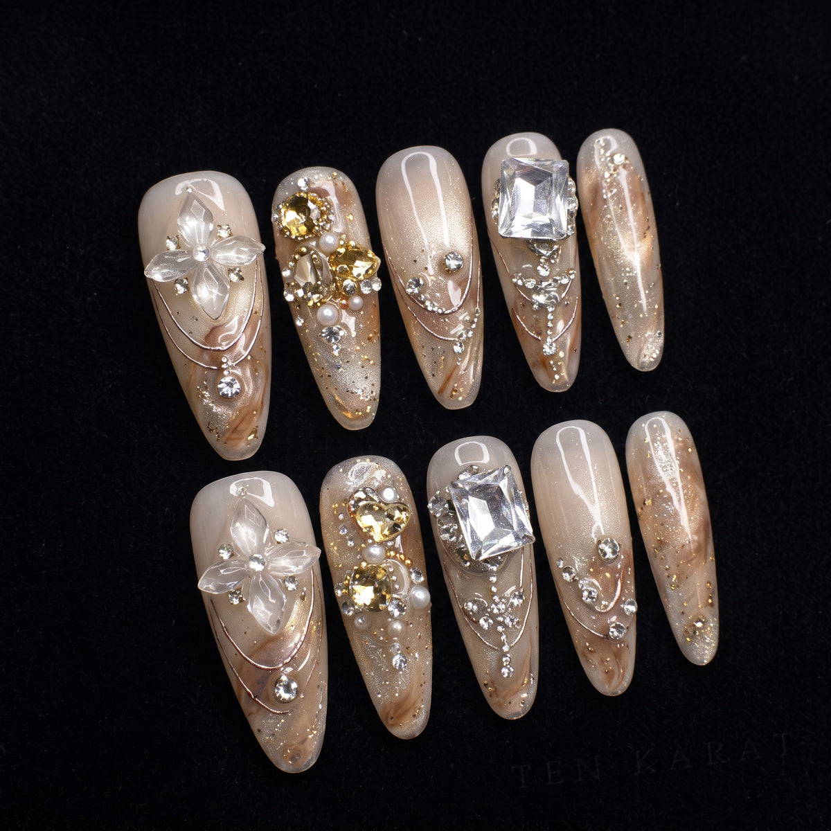 Champagne Diamond press-on nails on black velvet